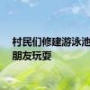 村民们修建游泳池供小朋友玩耍